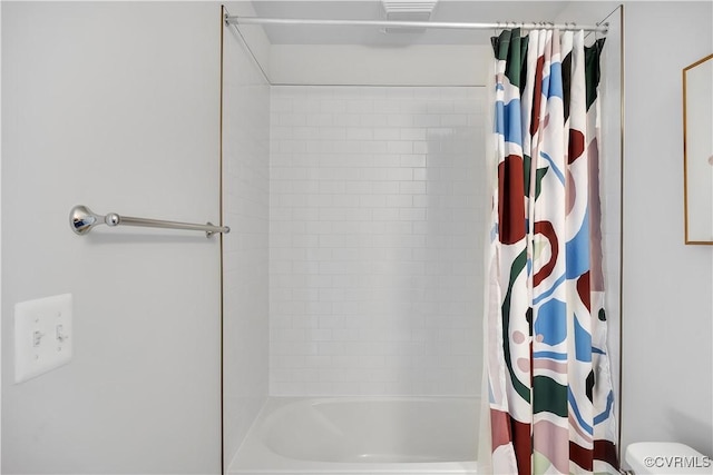 bathroom with toilet and shower / bath combo with shower curtain