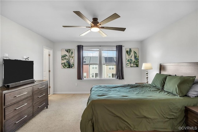 bedroom featuring ceiling fan and light carpet