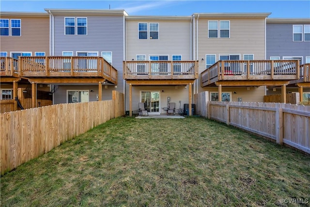 back of house with a yard and a patio