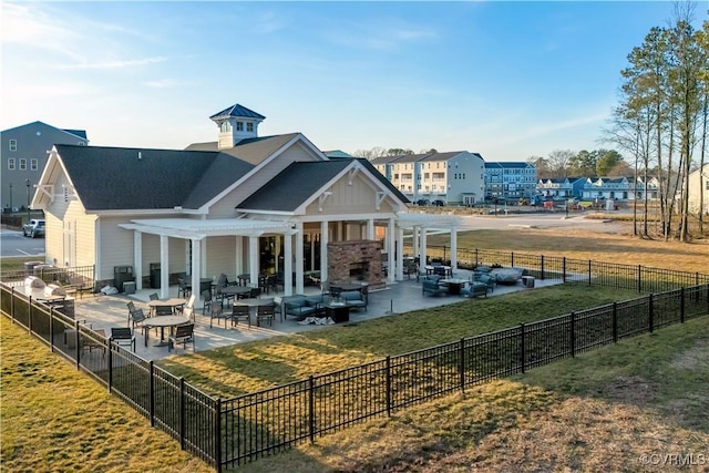 rear view of house featuring a lawn, a patio area, and a pergola