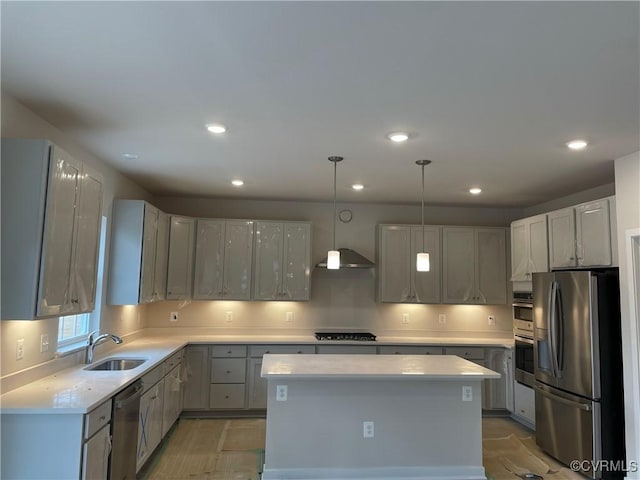 kitchen with a kitchen island, sink, gray cabinetry, hanging light fixtures, and stainless steel appliances