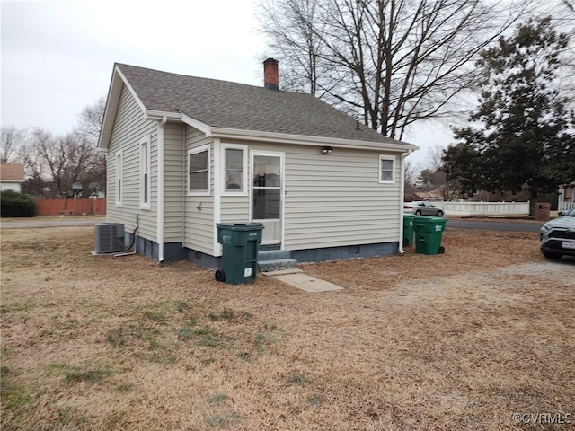 view of home's exterior featuring central AC and a lawn