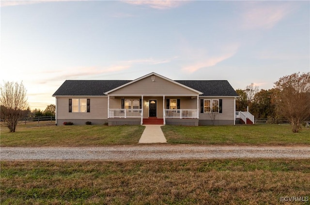 single story home featuring a yard and a porch