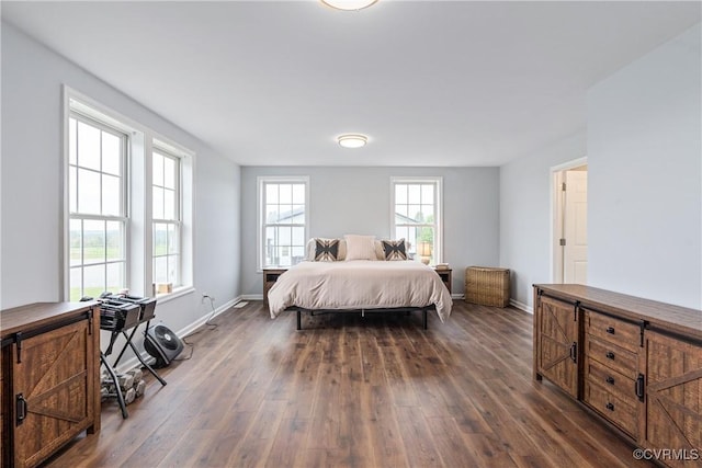 bedroom with dark hardwood / wood-style flooring