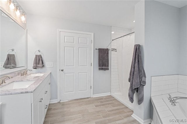 bathroom featuring vanity and separate shower and tub