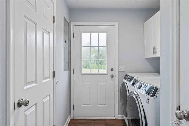 laundry room with cabinets, dark wood-type flooring, and washing machine and clothes dryer