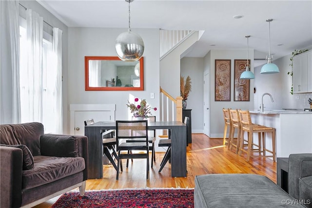 dining space featuring sink and light hardwood / wood-style floors