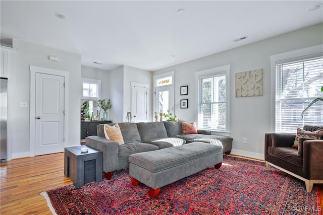 living room featuring light hardwood / wood-style floors and a wealth of natural light