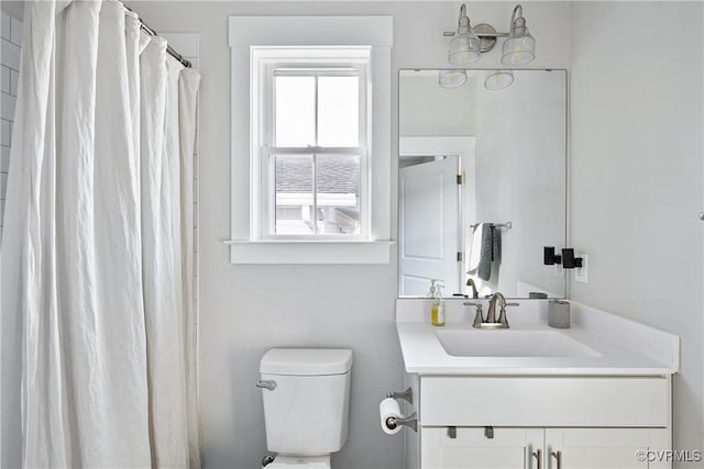 bathroom with vanity, toilet, and walk in shower