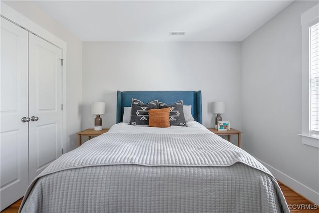 bedroom featuring hardwood / wood-style flooring and a closet