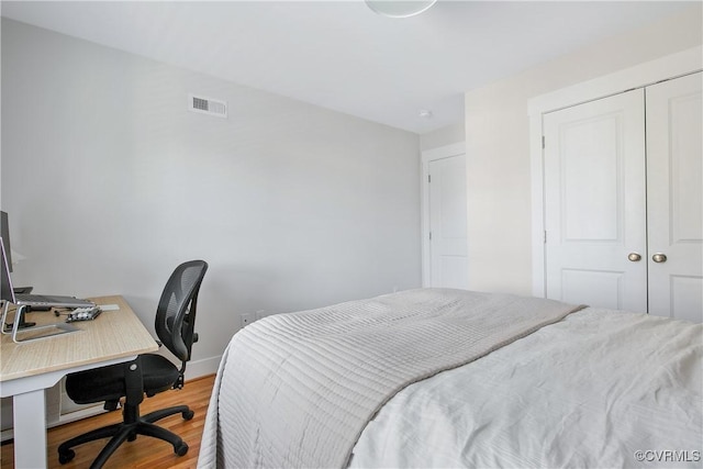 bedroom with hardwood / wood-style flooring and a closet