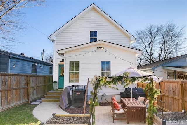 back of house with a patio area and central air condition unit