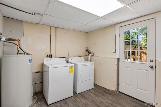 washroom with hardwood / wood-style flooring, gas water heater, and washer and dryer