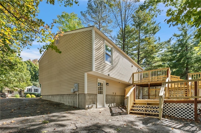 back of property featuring a wooden deck