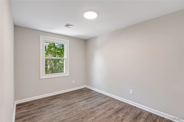 spare room with dark hardwood / wood-style floors