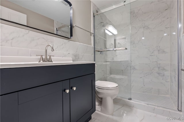 bathroom with tile walls, vanity, toilet, and walk in shower