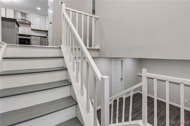 stairs featuring wood-type flooring