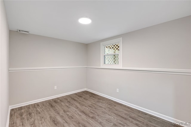 unfurnished room with hardwood / wood-style floors