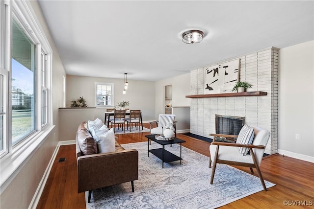 living room with a fireplace and hardwood / wood-style floors