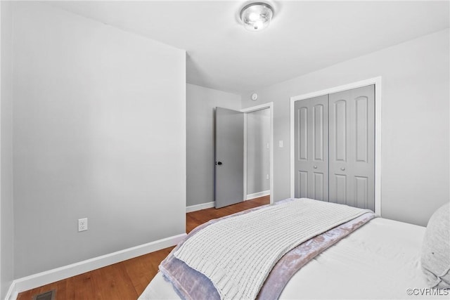 bedroom featuring hardwood / wood-style floors and a closet