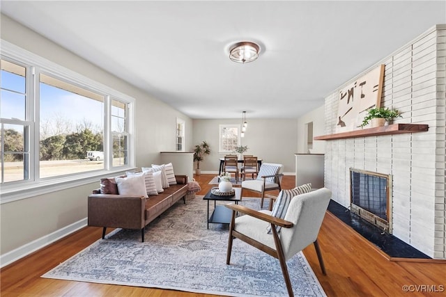 living room with hardwood / wood-style flooring and a fireplace