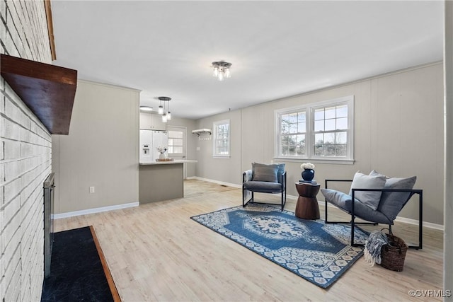 living area featuring a fireplace and light hardwood / wood-style flooring