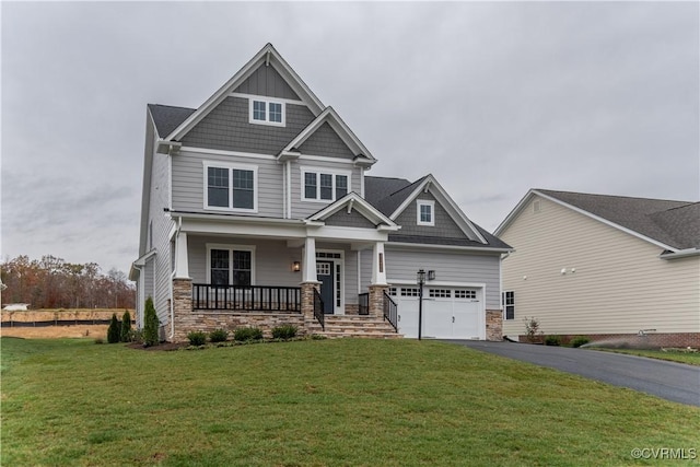 craftsman-style house with a garage, covered porch, and a front lawn