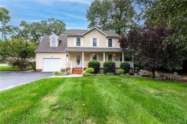 view of front of home featuring a porch, a garage, and a front lawn