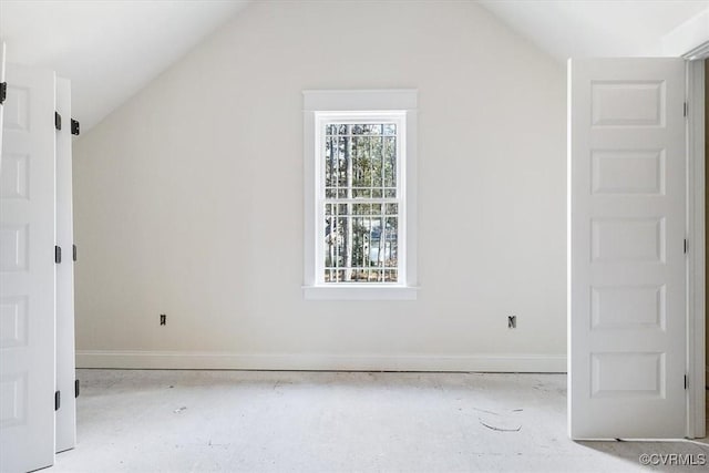 spare room with lofted ceiling