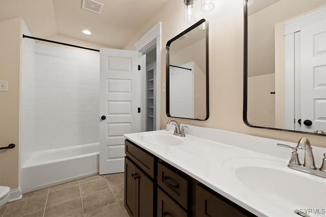 full bathroom featuring shower / washtub combination, lofted ceiling, vanity, toilet, and tile patterned floors