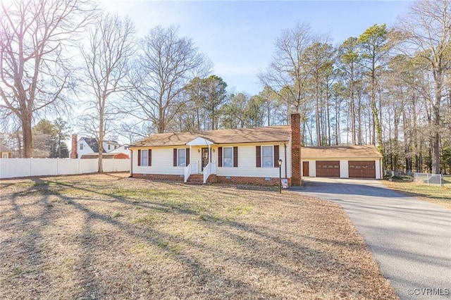 single story home featuring a garage and a front yard