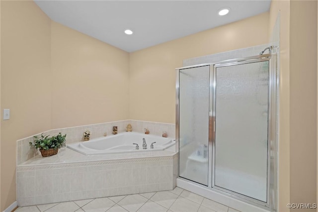 bathroom with tile patterned flooring and shower with separate bathtub