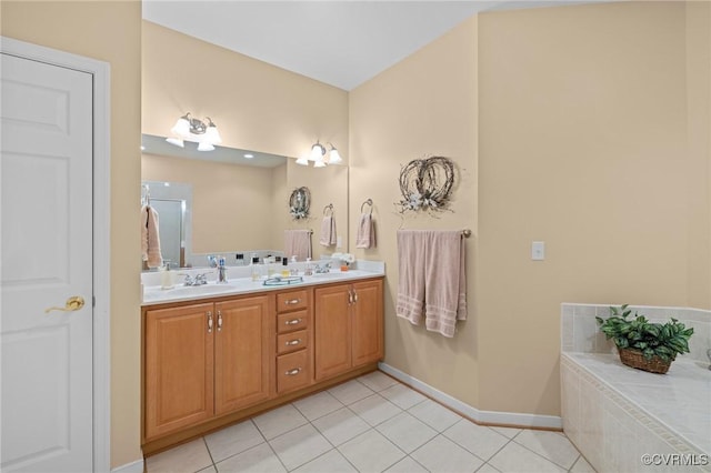 bathroom featuring vanity, tile patterned flooring, and tiled tub