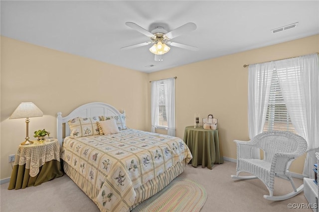 bedroom with ceiling fan and light carpet