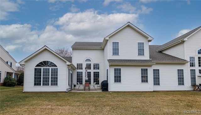 rear view of property with a patio area and a lawn