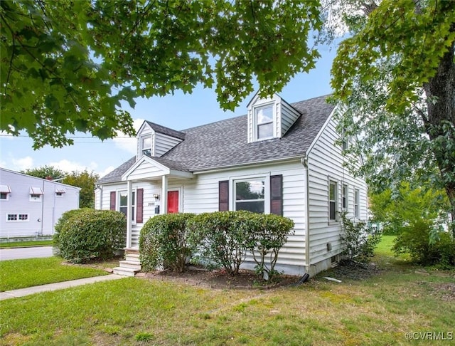 cape cod house featuring a front yard