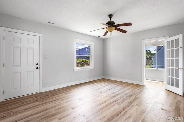 unfurnished room with ceiling fan and light wood-type flooring