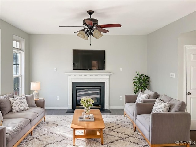 living room featuring wood-type flooring and ceiling fan