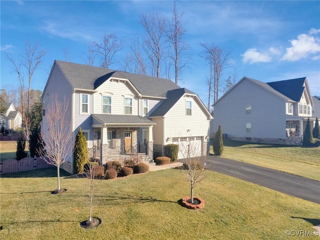 view of property featuring a porch, a garage, and a front yard