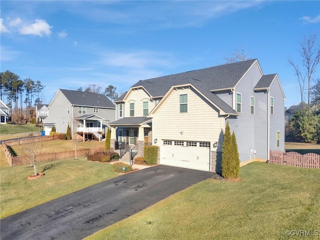 view of front facade featuring a garage, a front yard, and a porch