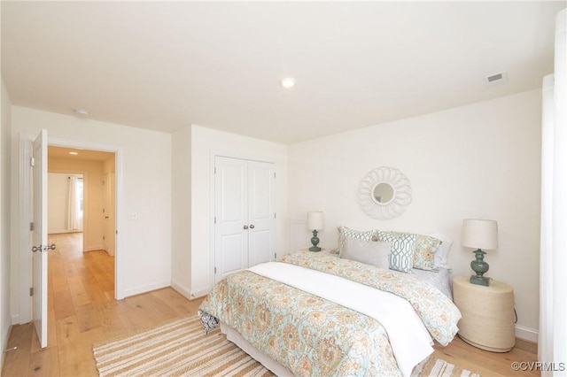 bedroom featuring hardwood / wood-style floors and a closet