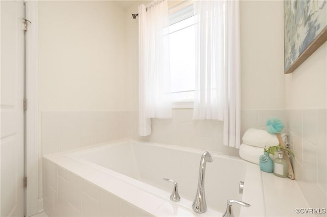 bathroom with tiled tub