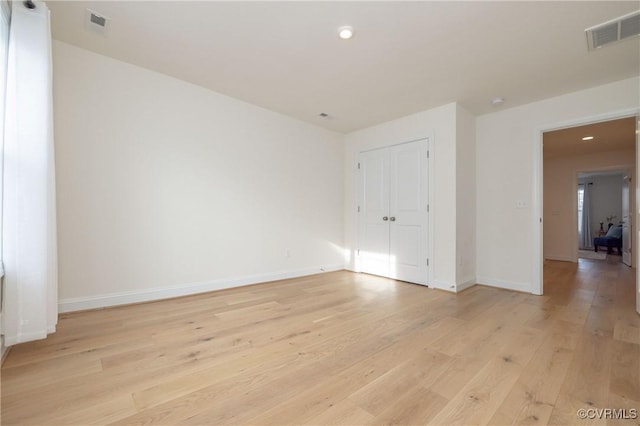 spare room with light hardwood / wood-style flooring