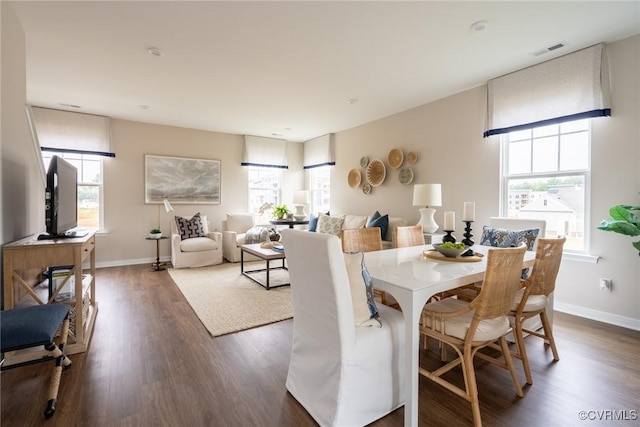 dining area featuring dark wood-type flooring