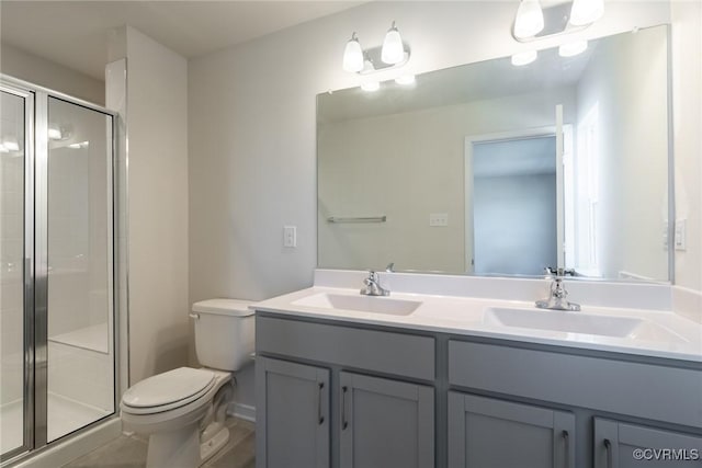 bathroom with vanity, an enclosed shower, and toilet