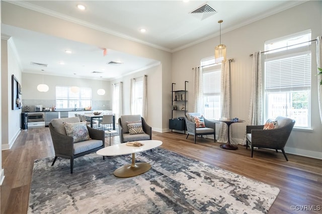 living room featuring ornamental molding and dark hardwood / wood-style flooring