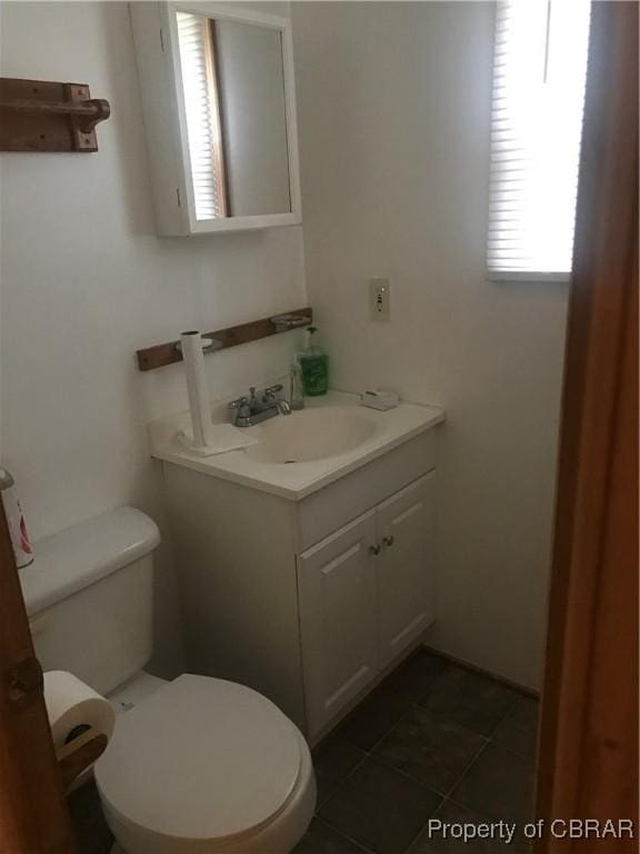 bathroom featuring tile patterned flooring, vanity, and toilet