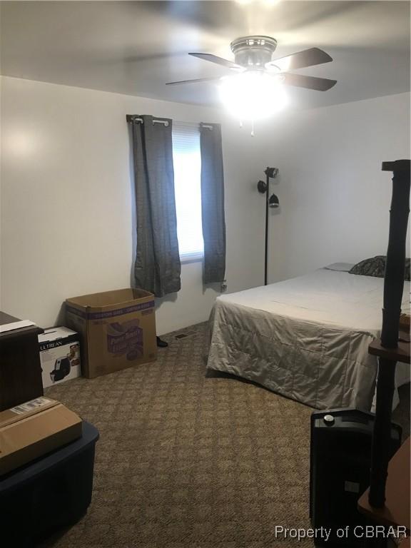 bedroom with ceiling fan and carpet