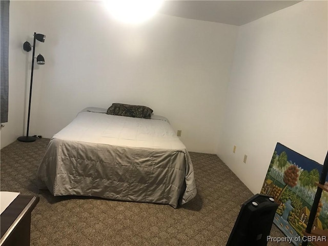 bedroom with dark colored carpet