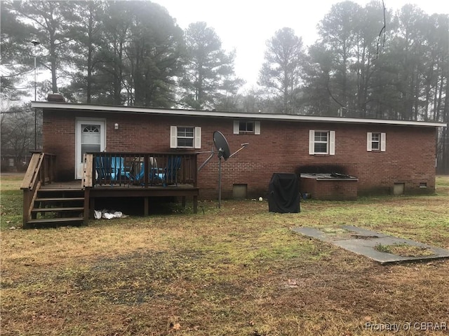 rear view of house with a yard and a deck